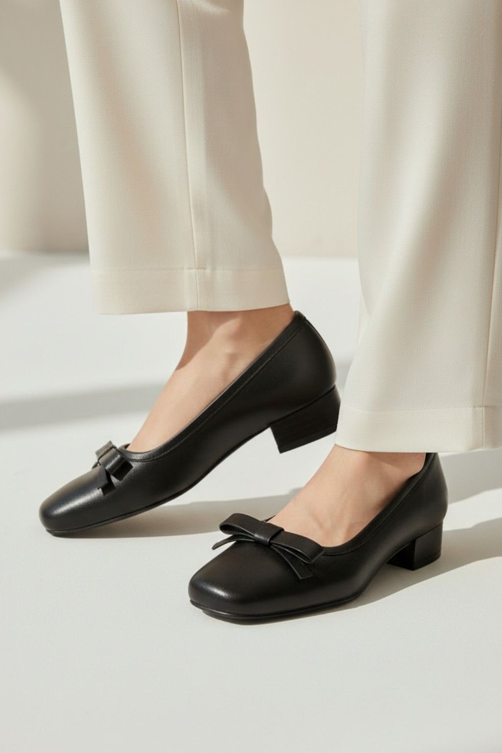 Arco Front Bow Pump Shoes, Black — 06 on the foot